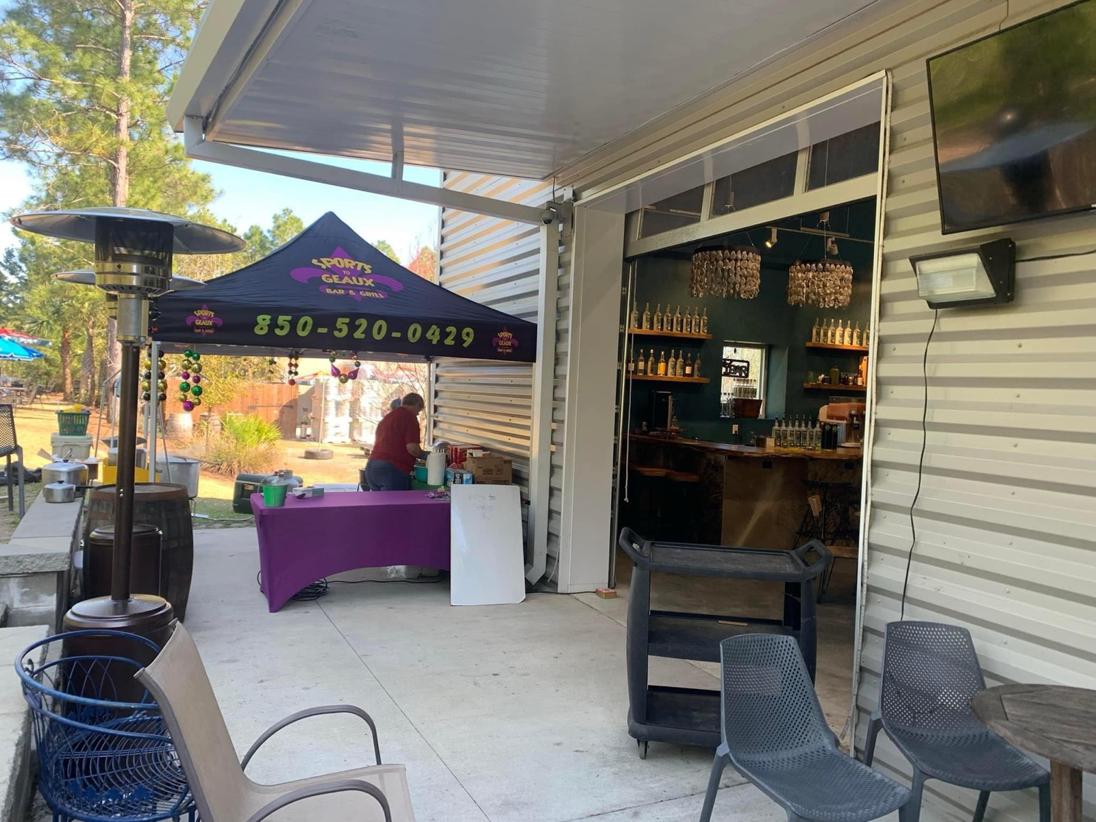 Patio dining setup with TVs